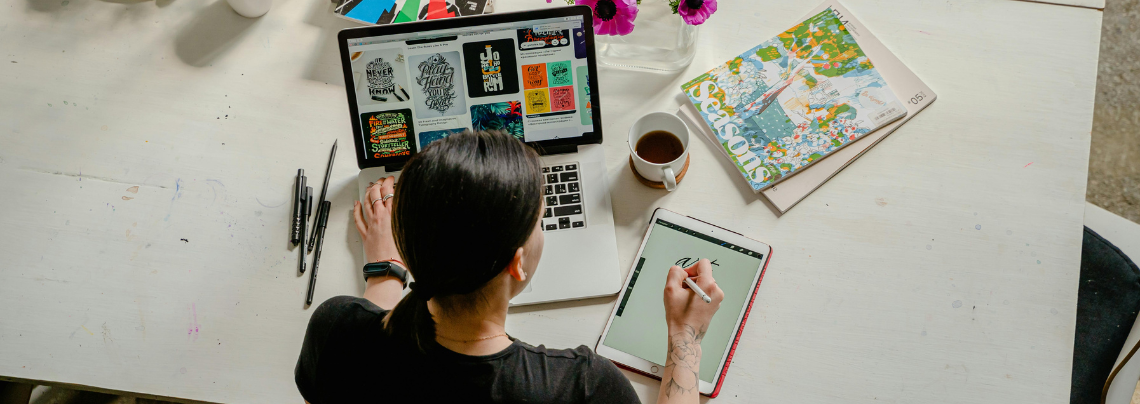 Novice designer woman working at front of laptop.