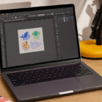 Doing designs on laptop.