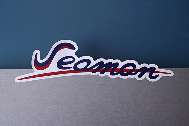 A "Seaman" script logo sticker with a white border.