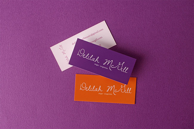 Colorful business cards for a singer-songwriter utilizing a loose, artistic handwritten script font.