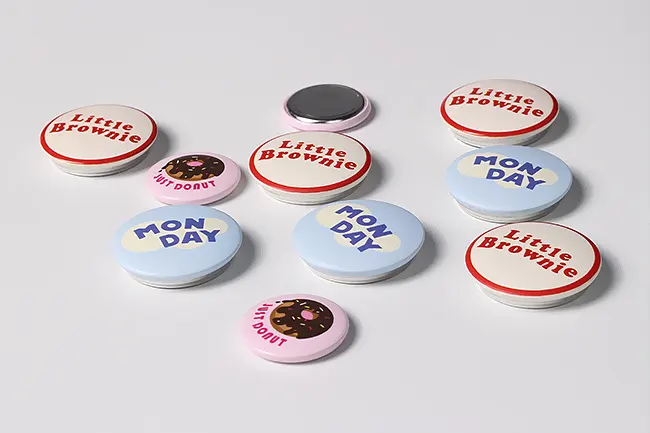 A variety of colorful badges showcasing creative marketing with stickers and magnets.