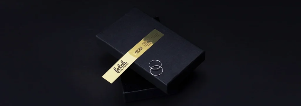 Gold foil brand sticker on a black jewelry box.