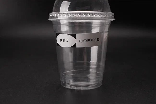 Vinyl label on a plastic cup showing how to design stickers for different materials.
