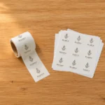 A label roll next to a sticker sheet on a wooden table, illustrating options for product labelling efficiency in Australia.